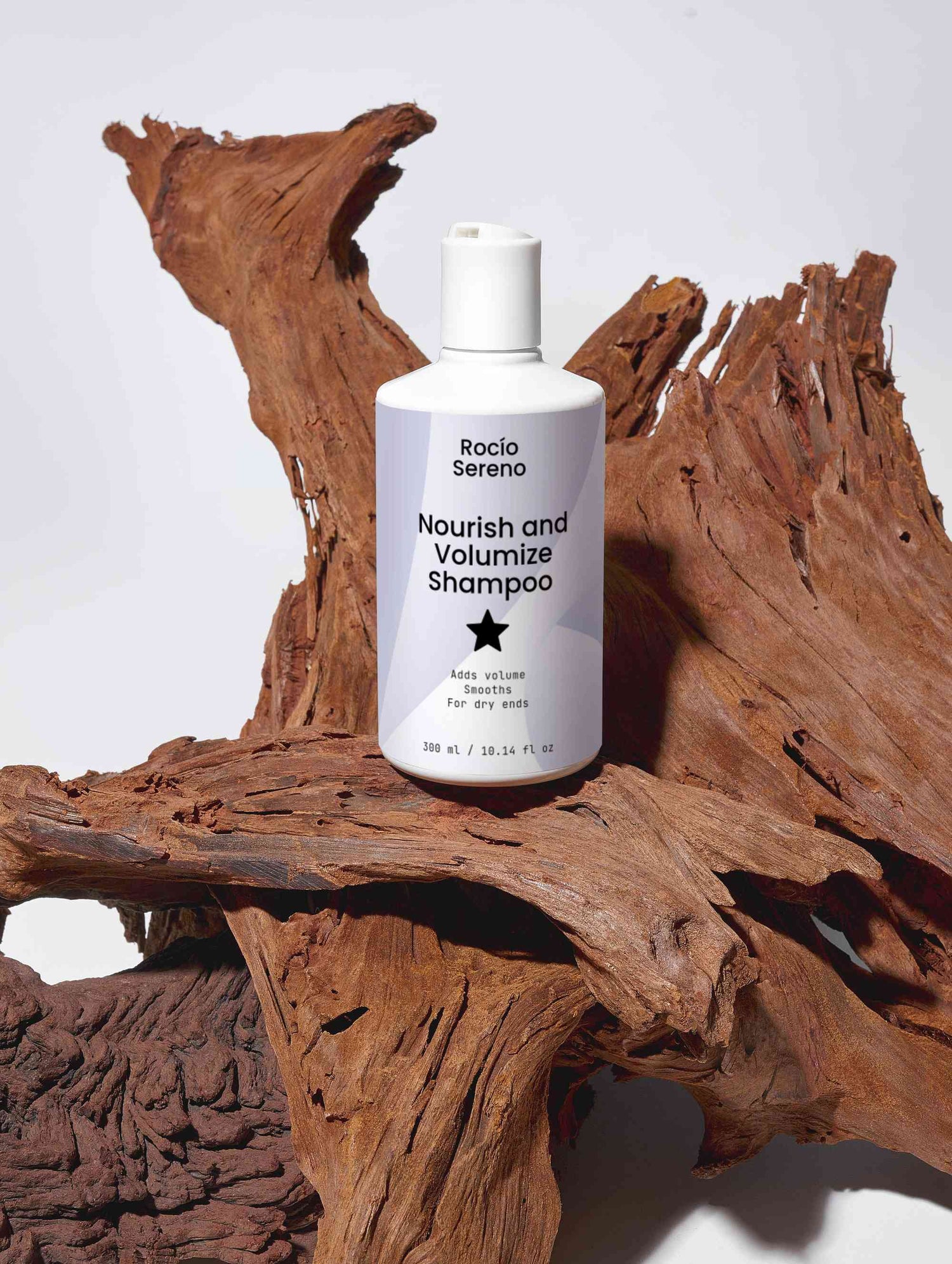 Nourish and Volumize Shampoo bottle with natural ingredients and white packaging for dry ends and volume hair care
