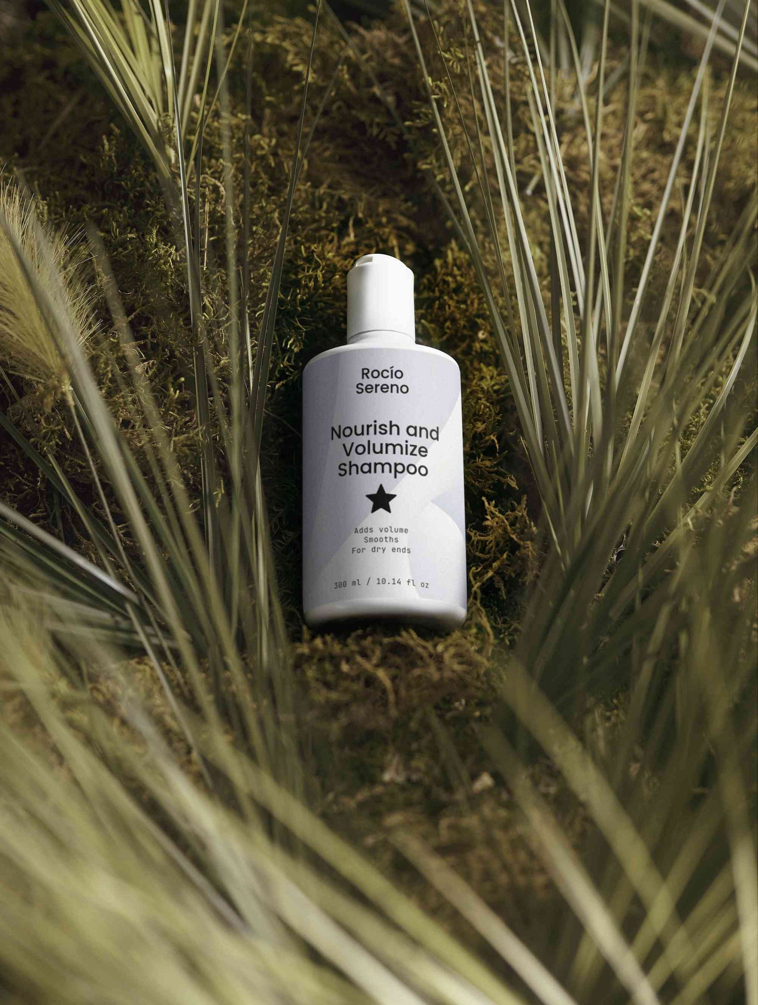 Nourish and Volumize Shampoo bottle with natural ingredients and white packaging for dry ends and volume hair care