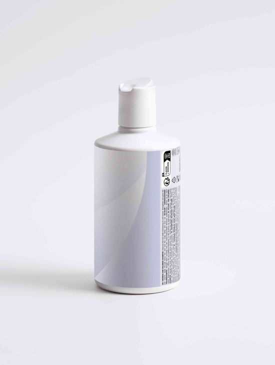 Nourish and Volumize Shampoo bottle with natural ingredients and white packaging for dry ends and volume hair care