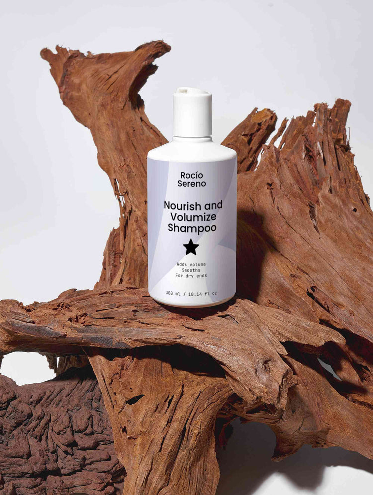 Nourish and Volumize Shampoo bottle with natural ingredients and white packaging for dry ends and volume hair care